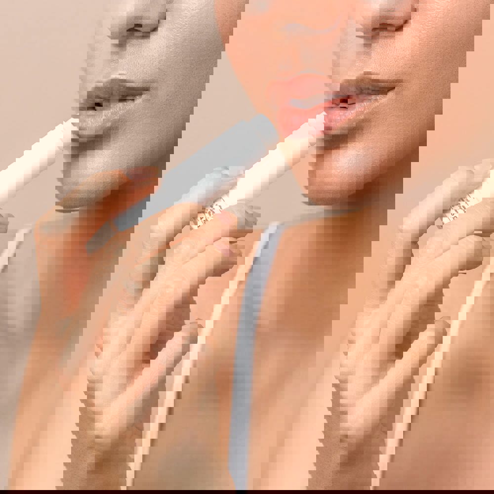 lips care and protection. woman applying balm on lips - Hidalgo