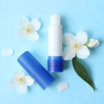 lip balm and flowers on a colored background close-up - Hidalgo