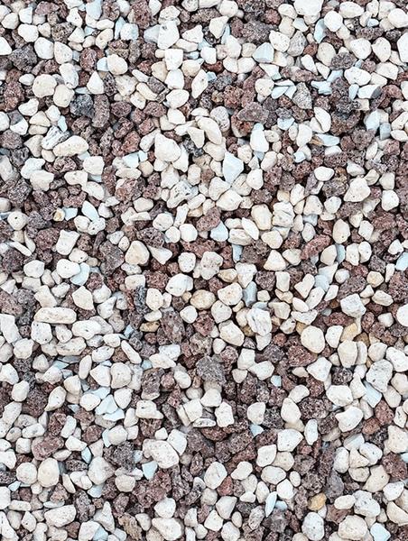 Close-up of small white and brown pebbles scattered on the ground.