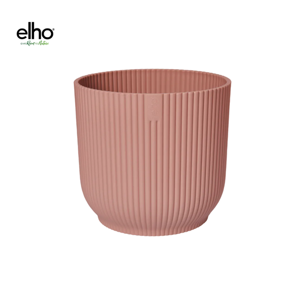 Pink ribbed planter pot by Elho, cylindrical with vertical grooves, empty and viewable from a slightly elevated angle.