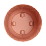 Top-down view of a pink circular silicone baking mold with fluted edges, four small internal feet, and the brand name 'elho' visible in the center.
