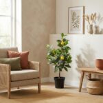 Bright living room corner with a potted lemon tree, woven-armchair with green and rust cushions, and a wooden table against a neutral wall.