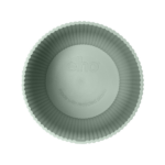 Top-down view of a green fluted cupcake liner with an embossed 'echo' logo and note that it’s made with recycled plastic.