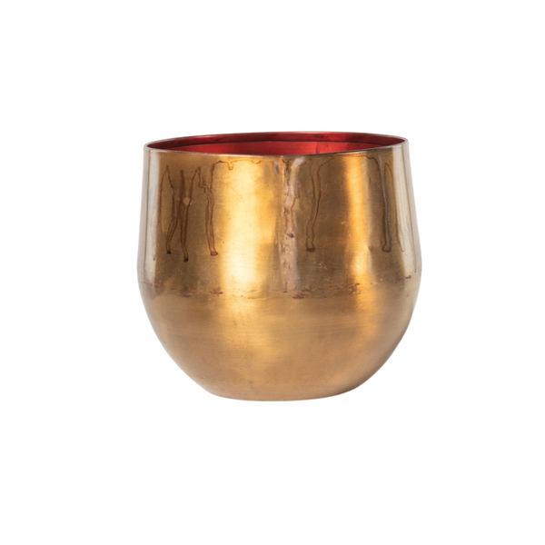 Brass drinking cup with a red inner lining and rounded base on a white background.