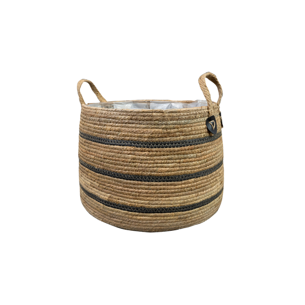 Round woven straw storage basket with two handles and dark horizontal stripes, lined inside with a white interior.