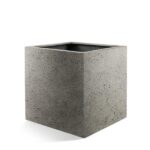 Square concrete planter with an open top, shown empty against a white background
