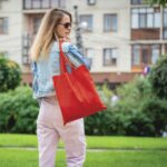 Young beautiful woman with linen eco bag on city background - Hidalgo