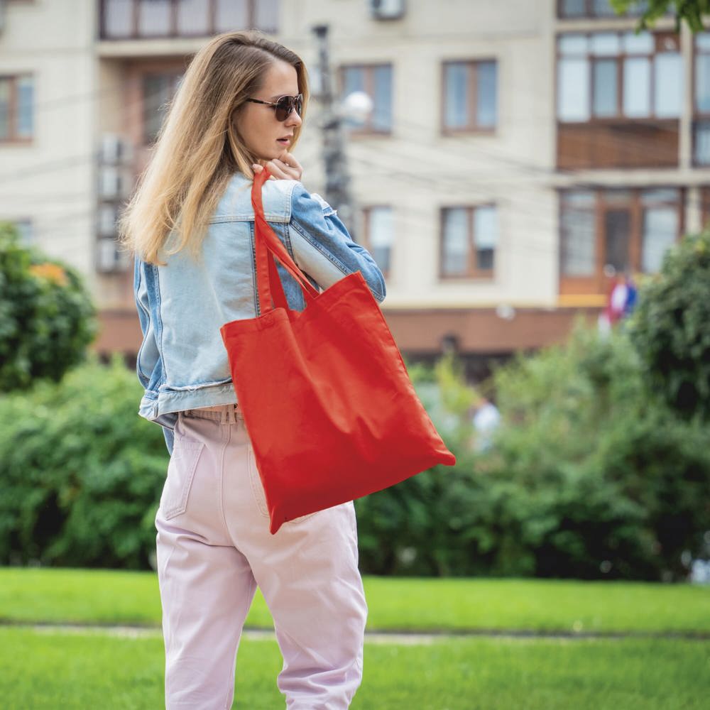 Young beautiful woman with linen eco bag on city background - Hidalgo