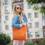 Young beautiful woman with linen eco bag on city background - Hidalgo