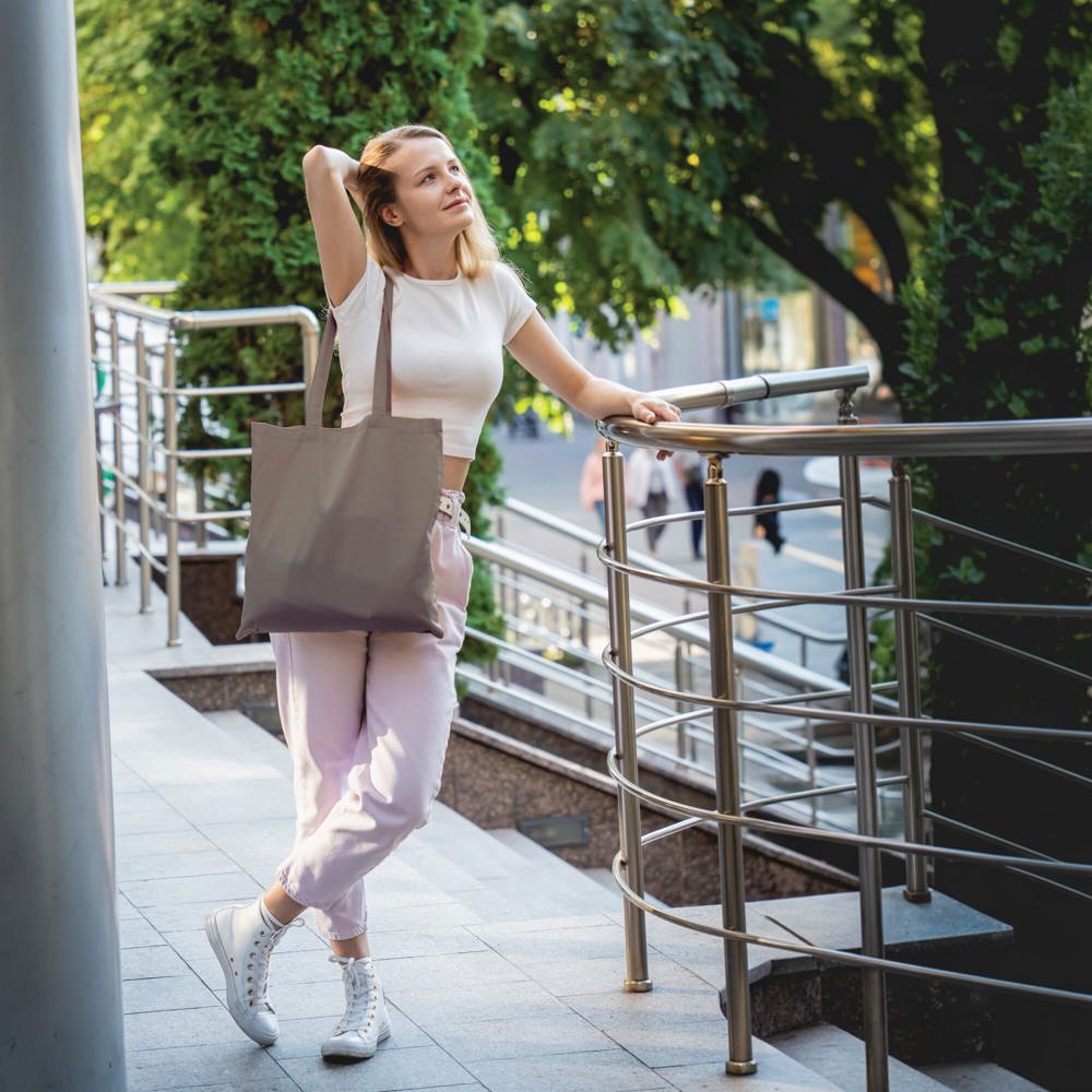Young beautiful woman with linen eco bag on city background - Hidalgo