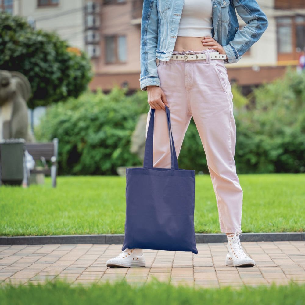 Young beautiful woman with linen eco bag on city background - Hidalgo