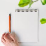 Spiral notebook leaves of a houseplant and an automatic pen tha - Hidalgo