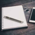 Pencil On A Blank Notebook Lying Next To A Business Smartphone On An Old Table - Hidalgo